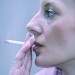 Close-up of woman's face with cigarette